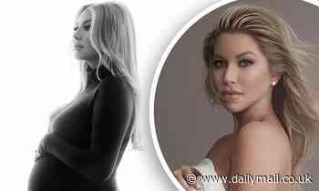 Stassi Schroeder cradles her baby bump in a retro-inspired black and white photo