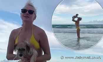 Bikini-clad Rose McGowan dotes on her pet pooch during trip to Mexico beach