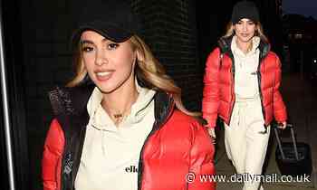 Love Island's Joanna Chimonides opts for in cream loungewear and a red quilted jacket in Manchester