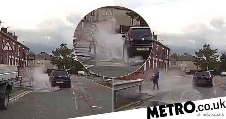 Moment driver ‘deliberately drives into puddle’ to splash boy
