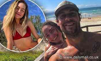 Ryan Gallagher cosies up to 800 Words actress Melina Vidler as they hit the beach in Byron Bay