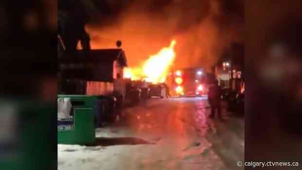 Late night fire destroys detached northeast garage, damages vehicles including boat
