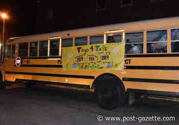 Plum opens its arms, and a bus, to donated toys