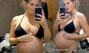 Pregnant Ashley James shows off her baby bump in a black bikini