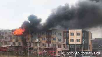 Massive fire breaks out in townhouse complex in Toronto, smoke drifting over Highway 401