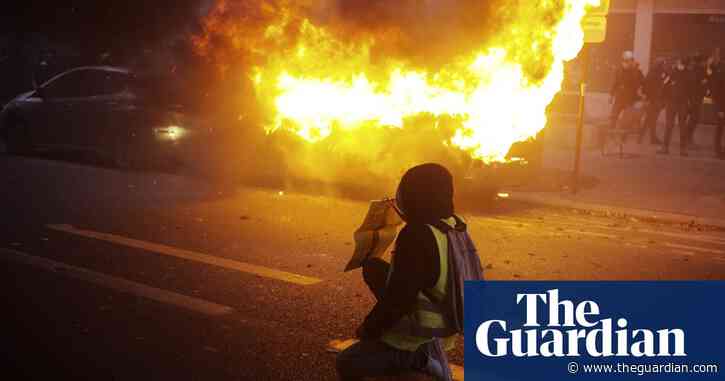 Vehicles set alight as thousands protest against police violence in Paris – video