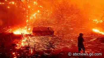 Wind fans wildfire in California canyons, residents flee