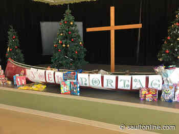 Filling a canoe with food items – Christmas sharing tradition remains strong