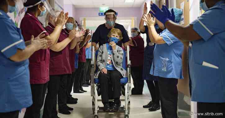 U.K. starts virus campaign with a shot watched round the world