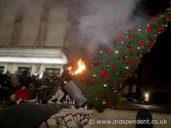 Albanian protestors burn Christmas tree after man ‘killed for breaking coronavirus curfew’