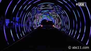 Parking lot of water park turned into drive-thru holiday light show with world's largest tunnel