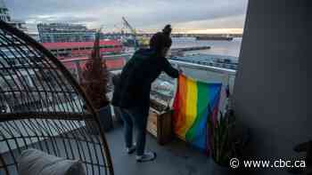 Vancouver couple ordered to remove rainbow doormat, flag after condo neighbours complain