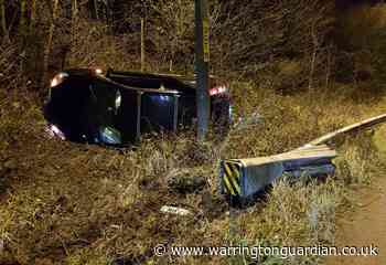 Car ends up on its side after collision on M56 slip road