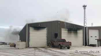 Fire crews pull semi-truck out of building during industrial fire in Corman Park