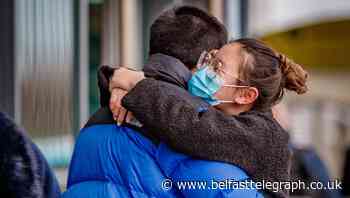 Relief: Hugs at Northern Ireland airport as passengers come home amid Great Britain flights ban chaos