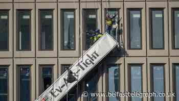 Window cleaners left dangling after explosion in high-rise building