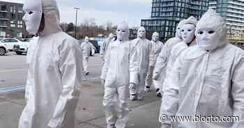 Masked people dressed in white stormed a Toronto mall to protest COVID vaccines - blogTO