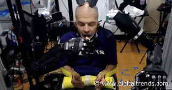 Man uses brain-controlled prosthetic robot arms to eat a Twinkie