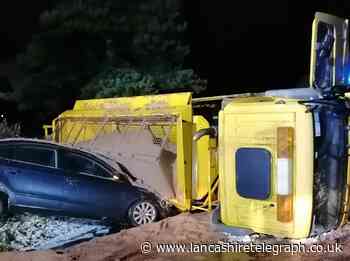 Gritting lorry overturns after crash with car in snow