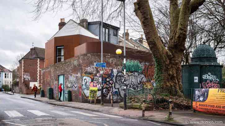 Barefoot Architects tucks weathering steel house and courtyard behind old brick wall