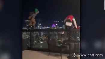 Watch these BASE jumpers leap from a hotel roof