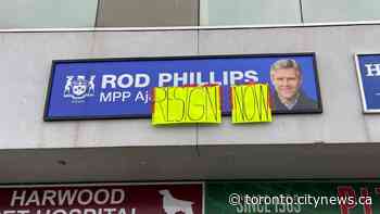 ‘Resign now’ banner taped on Rod Phillips’ constituency office sign - CityNews Toronto