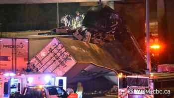 Transport truck crash on Highway 401 leaves driver trapped nearly 2 storeys up