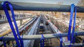 Thousands line route as Calgary police escort body of slain officer in formal procession to funeral home