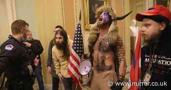 'QAnon Shaman' poses triumphantly in US Senate as Trump rioters storm US Capitol