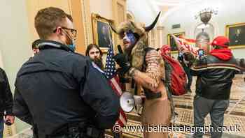 Man with painted face and ‘horns’ hat taken into custody after US Capitol mayhem
