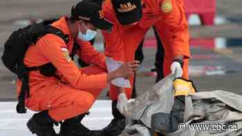 Indonesia officials say rescuers have found body parts, debris from plane crash
