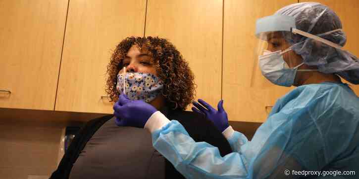 When should people who've already gotten COVID-19 get the vaccine? Doctors say it depends on whether they still have symptoms.