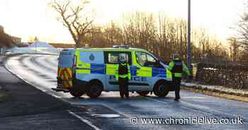 Police and paramedics at the scene after driver 'loses control' on icy road