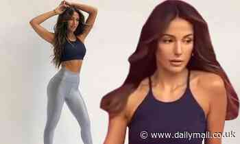 Michelle Keegan shows off her toned abs in a blue crop top and form-fitting silver leggings