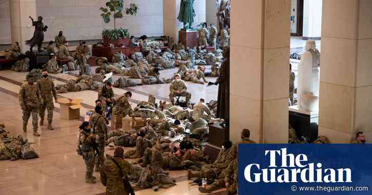 Hundreds of troops guarding US Capitol filmed resting during break in shifts – video