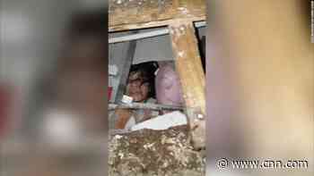 Woman who is trapped underneath earthquake's rubble captured on video