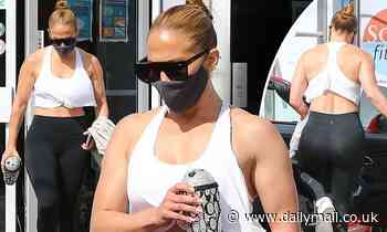 Jennifer Lopez puts her washboard abs on display in a white tank top for a workout at the gym