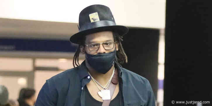 Cam Newton Shows Off Big Biceps At Airport Check In