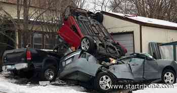 Car skids on ice, goes airborne and nose-dives onto 2 parked vehicles in Minneapolis