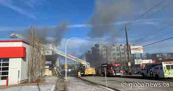 Crews battle active fire at Edmonton commercial building