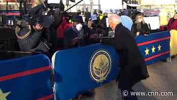 Biden fist-bumps members of the media during inaugural parade
