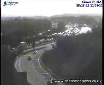 Three lanes closed and traffic building after crash on M60