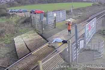Woman seen lying down on railway crossing to pose for photographs - Dudley News