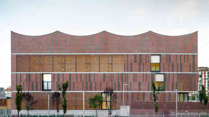 Assorted bricks give texture to facade of Camp del Ferro sports centre in Barcelona
