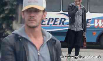 Jonathan Rhys Meyers puffs on a cigarette as he steps out amid claims he faces two criminal charges