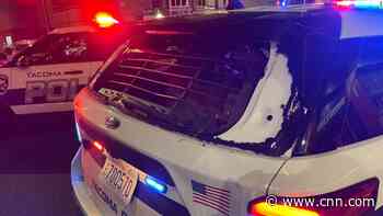 Crowd pounds cop's car, who then drives through them and injures at least 1