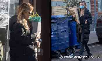 Abbey Clancy wraps up in a padded jacket  and sports a face mask as she steps out to pick up flowers