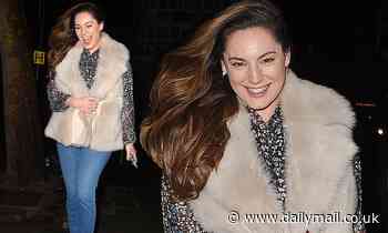 Kelly Brook cuts a chic figure in a fluffy gilet and patterned blouse