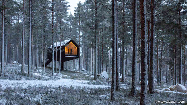 Studio Puisto balances black cabin on slender column in Finnish forest