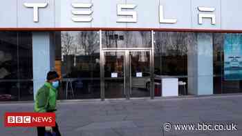 Tesla reports record deliveries but shares slide